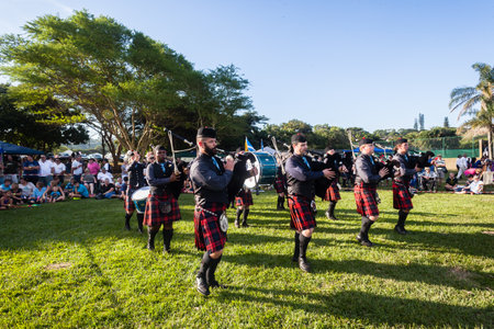 Scottish Bands men and women play musical instruments in traditional colors at the Scottish Highland Gathering のeditorial素材