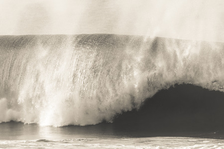 Ocean Wave crashing in vintage sepia tone mood contrastsの写真素材