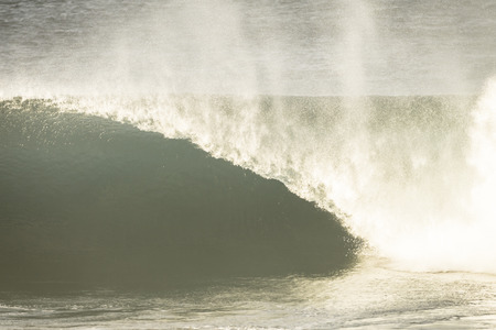 Ocean wave crashing curling lip in sepia vintage contrastの写真素材