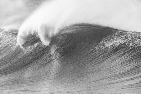 Ocean wave crashing curling lip in black white vintage contrastの写真素材