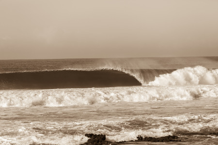 Ocean wave wall crashing curling lip in sepia vintage contrastの写真素材