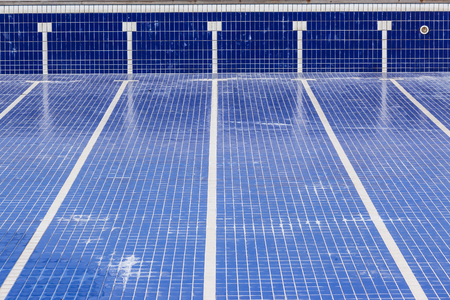 Swimming pool with blue tiles with swim lane tile markings empty of water for maintenanceの写真素材
