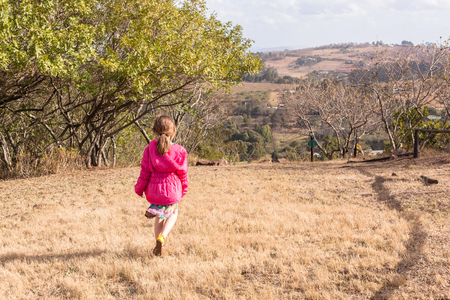 Young girl walking exploring in rural countryside nature reserveの写真素材