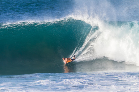 Surfing body boarding large hollow wavesの写真素材