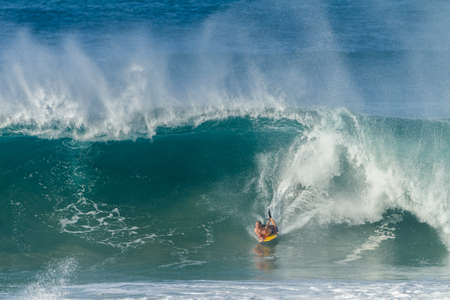 Surfing body boarding large hollow wavesの写真素材