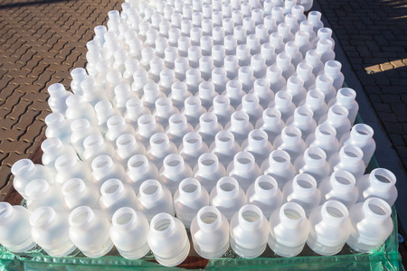 Plastic bottles dozens for athletes refreshment water drinks on collection table at marathon race