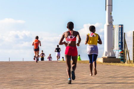 Girls participating in the Spar Marathon Race Walk held along beachfront promenade. Durban South-Africa 18th Sept 2014のeditorial素材
