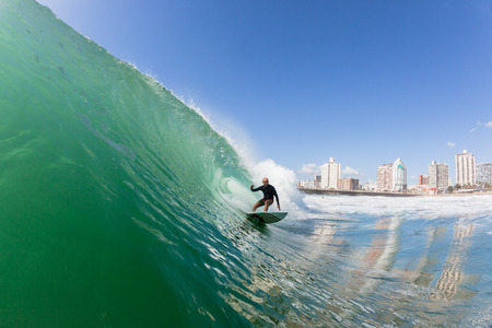 Surfing surfer rides ocean wave at North Beach Durban South-Africaの写真素材