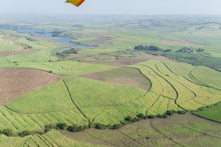 Microlight  Flying birds eye view of river terrain and green landscape horizonの写真素材