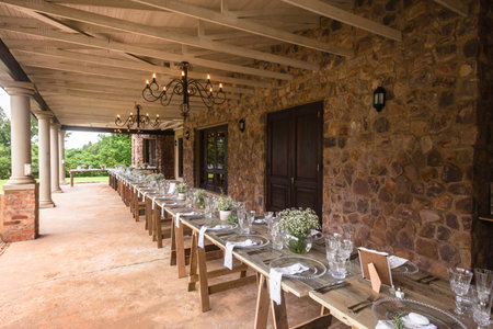 Wedding decor chairs ceremony lawn pool landscape with guests lunch dinner table settings on porch verandaのeditorial素材