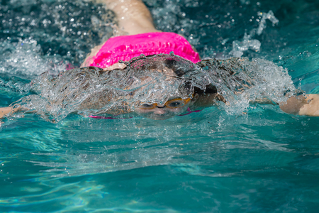 Girl teenager diving swimming pool underwaterの写真素材
