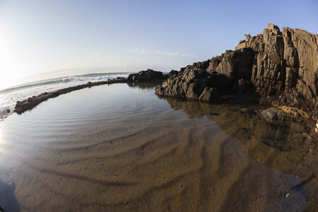 Rocky tidal pool for swimming ocean waves landscapeの写真素材
