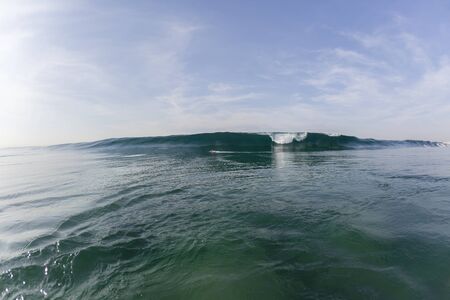 Surfing surfer escapes wave crashing ocean power