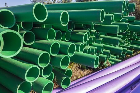 Pipes poly prop plastic color closeup abstract background stacked roadside for underground communiction cablesの写真素材