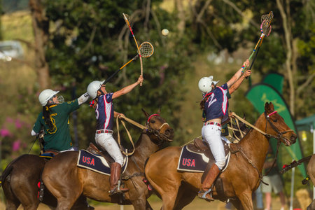 Polocrosse sport world-cup game action South-Africa v USA women player riders at Shongweni equestrian fieldsのeditorial素材