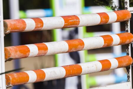 Equestrian horse show jumping gates poles colors on arena course.の写真素材