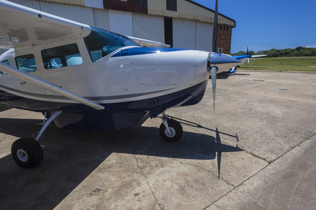 Aircraft single prop plane outside hangar airstrip