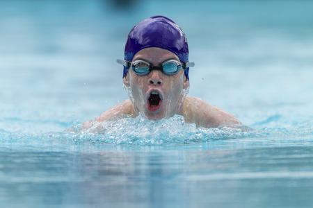 Swimming boy teen breastroke style race.の写真素材