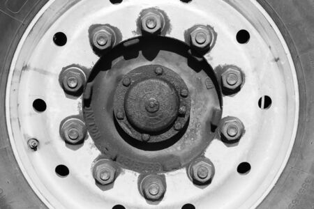 Truck industrial tyre wheel rim locking nuts closeup abstract detail black and whiteの写真素材