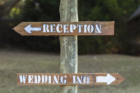 Signs wedding inquiries reception outside rural countryside wood pole materials.の写真素材