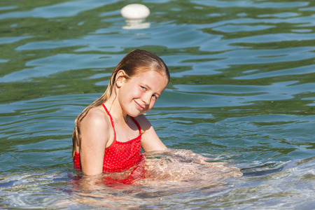 Young girl relaxing swimming pool waterの写真素材
