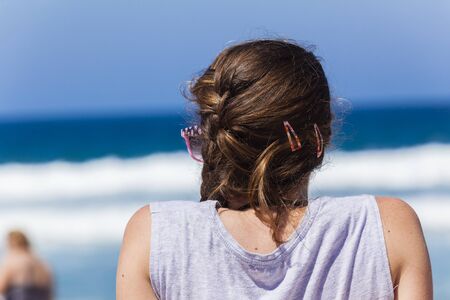 Girl teenager beach sunglasses relaxing holiday ocean landscapeの写真素材