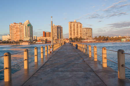 Durban beachfront ocean pier surfing surfers morning landscape.の写真素材