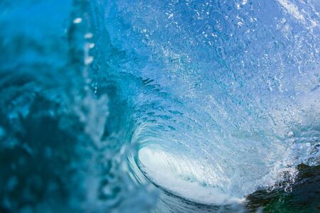 Ocean wave swimming inside hollow crashing surfing tube ride perspective.の写真素材