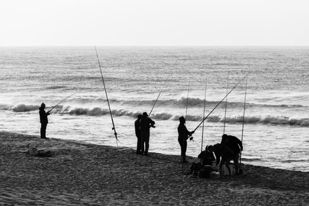 Fishermen fishing beach ocean vintage black and whiteのeditorial素材