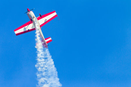 Aircraft acrobatic plane pilot in flying action.