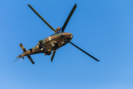 Helicopter military aircraft  flying flyby closeup action blue sky.のeditorial素材