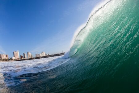 Ocean wave closeup swimming inside hollow crashing blue water.の写真素材