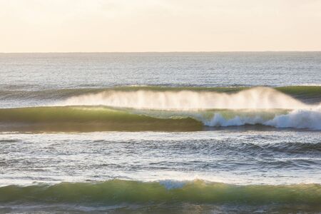 Waves crashing ocean water towards beach coastlineの写真素材