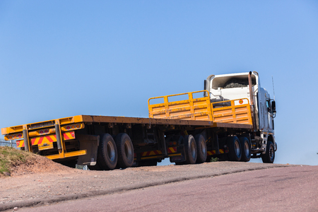 Truck vehicle with yellow haulage trailers awaiting cargo to transport.の写真素材