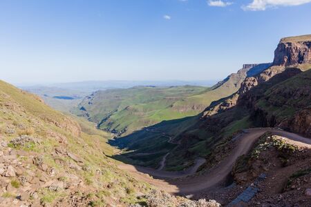 Mountain dirt road up sani-pass rugged route scenic rural mountain valley landscapeの写真素材