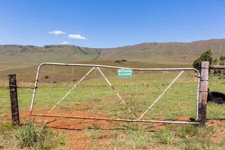 Mountains farm gate sign no fishing no hunting farmer property.の写真素材