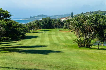 Golf course par four hole coastline ocean landscape.の写真素材