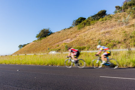 Cyclists cycling speed blur motion road race landscape.のeditorial素材