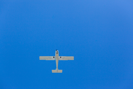 Plane light propeller aircraft flying blue sky upward photo.