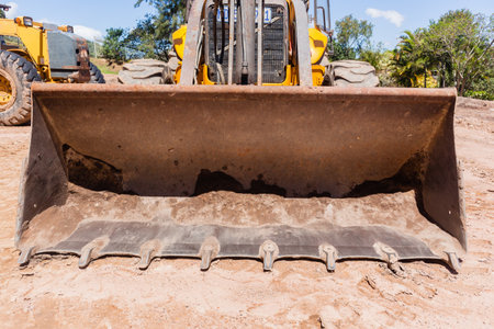 Industrial earthworks bulldozer grader bucket scoop closeup machine on construction site.のeditorial素材
