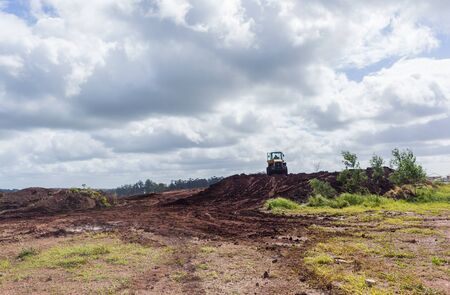 Industrial earthworks grader dozer bucket machine on building construction site.