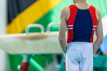 Gymnastics teenager male unidentified abstract ready for horse apparatus routine action closeup photo. speed blur routine action closeup photo.の写真素材