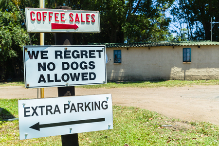 Outdoors farm signs coffee sales no dogs extra parking rural countryside public directions.の写真素材