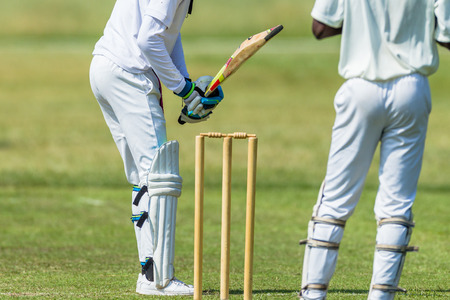 Cricket game action closeup unidentified abstract bowler batsman wicketkeeper.の写真素材