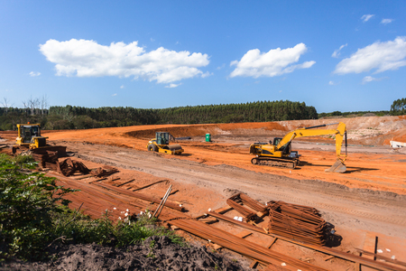 Construction industrial earthworks machines for new bridge structure over countryside highwayの写真素材