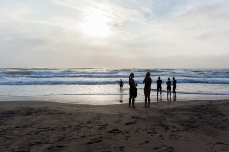 Triathlon beach athletes silhouetted swim preparation for race start in ocean water course at dawn sunriseのeditorial素材
