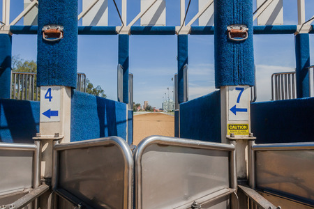 Horse racing inside starting gate compartment for each horse and jockey ready for race action.の写真素材
