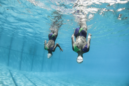 Aquatic synchronized unidentified girls swimmers dance moves closeup underwater vintage aged photo action.の写真素材