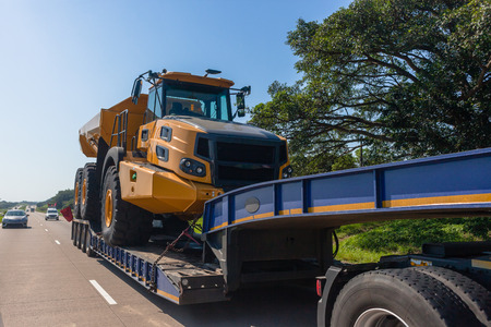 Abnormal vehicle haulage low bed trailer transportation delivery of new large heavy industrial...
