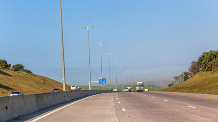 Road highway traffic trucks vehicles on road photo on the move going away from town city into...